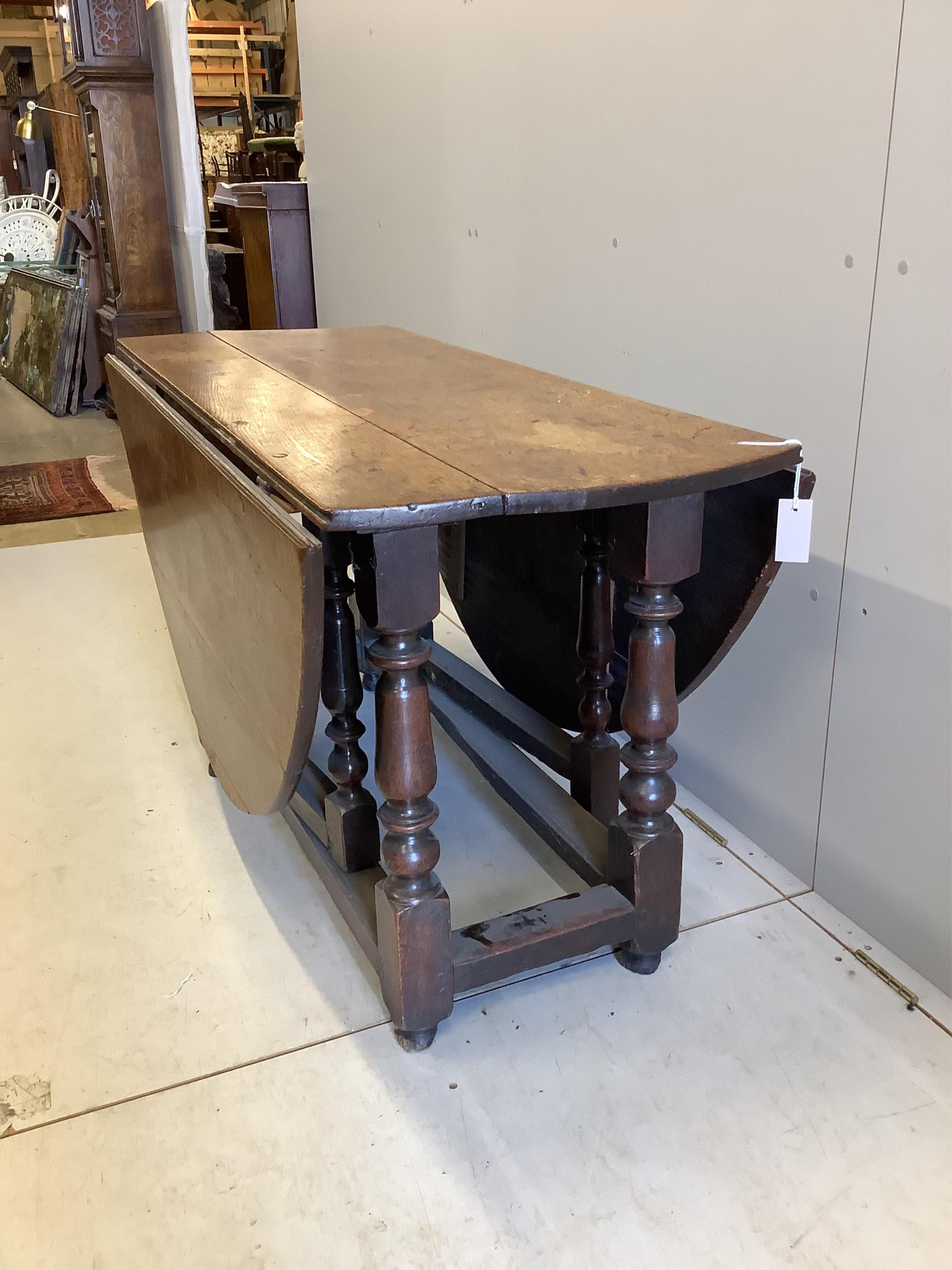 An 18th century oak gateleg table, width 135cm, depth 55cm, height 73cm. Condition - poor to fair